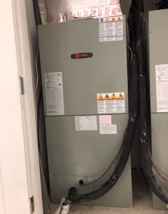 Residential HVAC air handler unit installation inside home utility closet